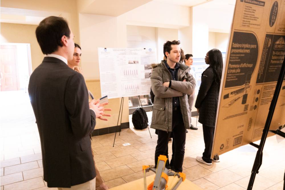 Students viewing posters at the 2023 Graduate Showcase.